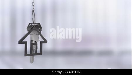 House-shaped keychain with keys hanging, real estate concept image Stock Photo