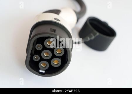 Close up of a female Type 2 electric vehicle charging cable connector on white background Stock Photo