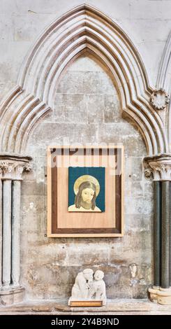 Iconic image of Jesus Christ above a sculpture of the good samaritan, in Lincoln cathedral, England. Stock Photo