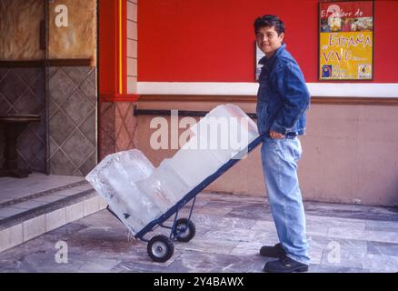 Mexico, Mexico-City.Boy brings ice blocks to a restaurant where there is no freezer. Stock Photo
