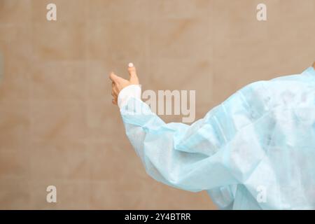 Medical team in protective gear preparing for surgery in a sterile environment. Stock Photo