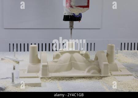 Mold making process from epoxy tooling board on a CNC router machine. Selective focus. Stock Photo