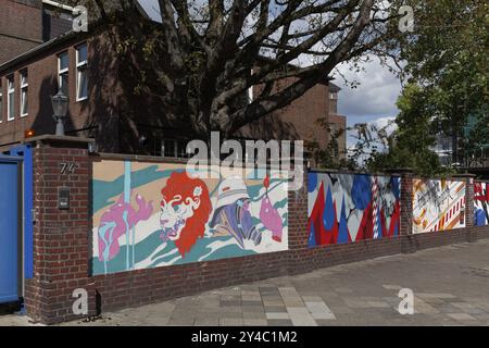 A row of colourful paintings on an old brick wall, decorative street art commissioned by the city of Duesseldorf, North Rhine-Westphalia, Germany, Eur Stock Photo
