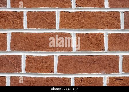 Background of a red brick wall with white joints Stock Photo