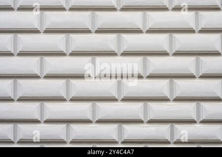 Background consisting of a wall with rectangular grey stone slabs Stock Photo