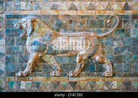 This striking lion frieze, crafted from stone, showcases a powerful lion in relief, part of the Near Eastern Antiquities collection at the Louvre Museum in Paris, dating back to Darius I's era. Stock Photo