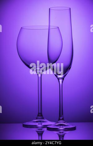 Two empty wineglasses on a purple background Stock Photo
