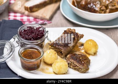 Home-style beef roulade with red cabbage and potato dumplings Stock Photo