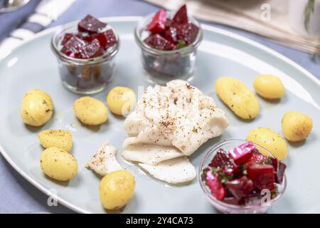 Fried cod fillet with roast potatoes and beetroot salad Stock Photo - Alamy