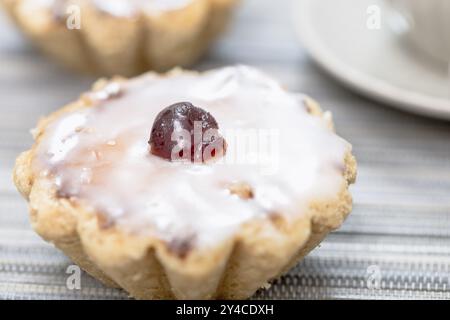 Marzipan biscuits with sugar icing and candied cherries Stock Photo