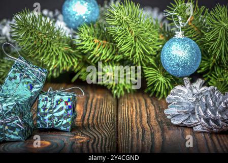 Blue balls and gift boxes with fir branch on wooden table Stock Photo