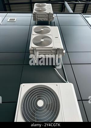 Commercial building with external air conditioning units and metal framework. Stock Photo