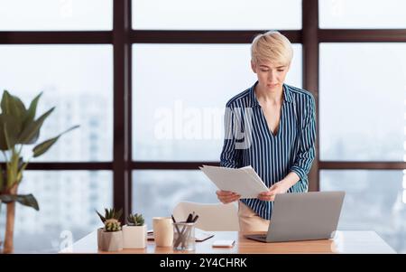 Business Woman Checking Documents Working Standing In Modern Office Stock Photo