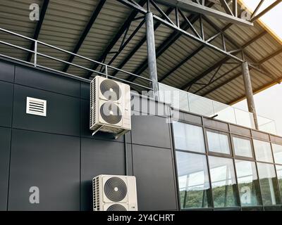 Commercial HVAC system installed on building exterior with glass, steel design Stock Photo
