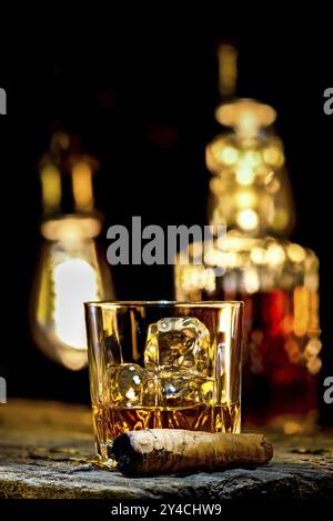 Whiskey in glass and cigar on wooden table Stock Photo