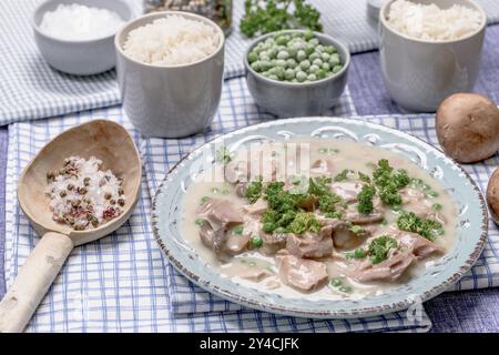 Chicken fricassee with mushrooms and peas Stock Photo