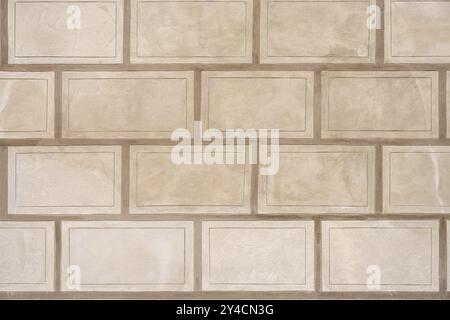 Background consisting of a wall with rectangular beige stone slabs Stock Photo