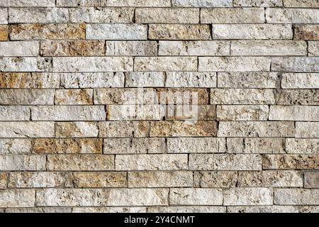 Background consisting of a wall of beige and brown clinker bricks Stock Photo