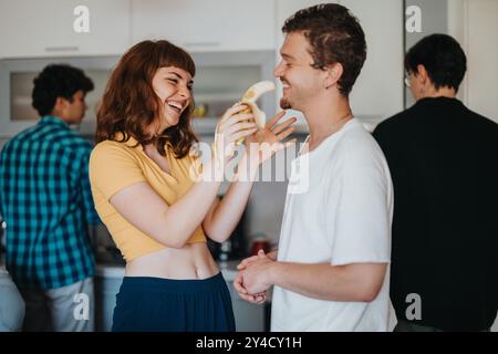Friends enjoying a lighthearted moment in the kitchen Stock Photo