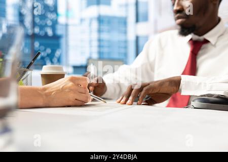 Worker with paraplegia attending corporate training session, engaged in continuous learning and career advancement in inclusive workplace. Wheelchair user at work receiving equal chances Stock Photo