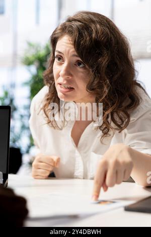 Woman feeling upset after being deemed unsuitable for position by HR expert vetting applicants. Lady disappointed by headhunter rejecting her CV after finding her work experience unsatisfactory Stock Photo