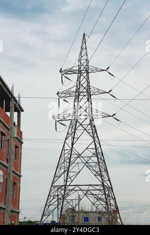 Transmission tower in a developing area Stock Photo