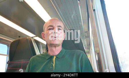 A man travels on a train. An elderly man is on a train. The concept of daily routine and commuting to work Stock Photo