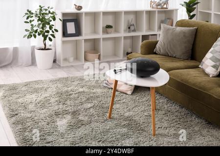 Interior of living room with green sofa and glucophone on table Stock Photo