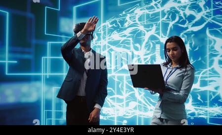 Engineers use VR smart goggles and AI neural networks to solve company problems. IT experts using artificial intelligence and AR virtual reality tech to visualize startup business data, camera B Stock Photo