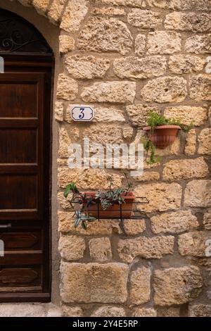 Rustic Stone Wall with Potted Plants Stock Photo