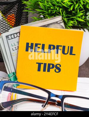 Helpful Tips words on a yellow sticker, vertical concept photo Stock Photo