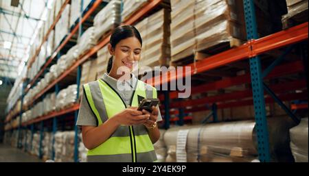 Phone, engineer and woman in warehouse for shipping, distribution or stock inspection on app. Mobile, logistics and happy factory worker check Stock Photo