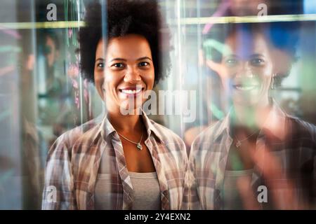 Portrait of african american female IT developer, programmer, designer working with programming code Stock Photo