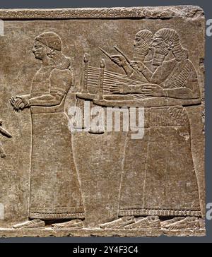 7381. Assyrian king Ashurnasirpal II, 883-859 BC. (centre), relief showing musicians at a celebration in the Royal court in Nimrud, Northwest Palace. Stock Photo