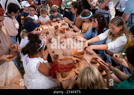 A child making pottery in the style of the Middle Ages during a workshop at the Fete des Remparts in the medieval town of Dinan in the Cotes-D Armor r Stock Photo