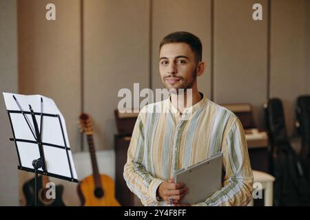 Portrait of Young Man Holding Tablet in Music Studio Stock Photo
