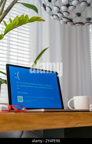 Prague, Czech Republic - September 13, 2024: Blue screen of death on a laptop at home office Stock Photo