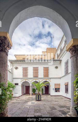 Seville, Spain, Nov 15 2009, The peaceful inner courtyard of the Santa Isabel convent showcases historical architecture and lush greenery in Seville, Stock Photo