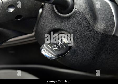 Car key in ignition. Contact lock for activating the car engine and ignition key. Stock Photo