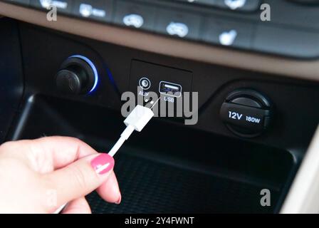 Hand plugging a key shaped USB drive into port Stock Photo