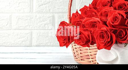 A bouquet of red roses in basket on a white background. Blooming flowers, festive concept for Mother's Day or Valentine's Day. Greeting card, Easter f Stock Photo