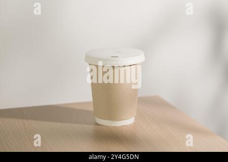 This mock-up features a paper cup ideal for takeaway hot coffee or hot drinks. The design highlights the convenience of single-use cups while promotin Stock Photo