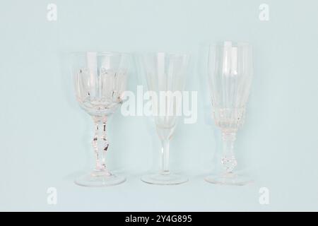 Three vintage crystal glasses on a blue background. Stock Photo
