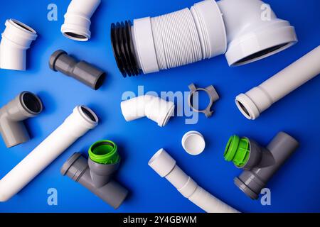 PVC drainage pipes and fittings on blue background. top view Stock Photo