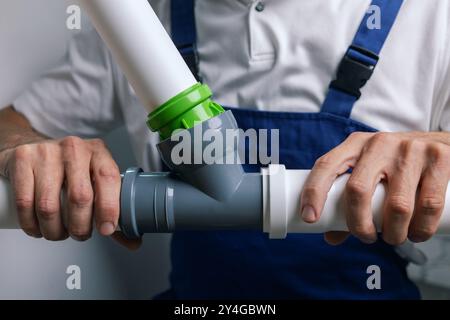 PVC pipes installation. plumber installing drain pipeline Stock Photo
