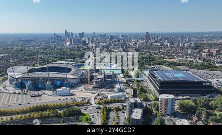 An aerial view of the Etihad Stadium, constriction of the new stand and the City of Manchester in the background during the UEFA Champions League league stage match Manchester City vs Inter Milan at Etihad Stadium, Manchester, United Kingdom, 18th September 2024  (Photo by Mark Cosgrove/News Images) Stock Photo