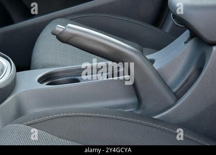 Manual brake in interior of modern car. Car parking brake. Stock Photo