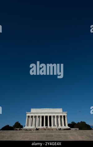 WASHINGTON DC, United States — A wide-angle view of the eastern side of the Lincoln Memorial, with its neoclassical columns rising against a clear blue sky. The shot captures the grandeur of the memorial from the plaza, showcasing one of Washington DC's most iconic landmarks, designed by architect Henry Bacon and featuring a statue by sculptor Daniel Chester French. Stock Photo