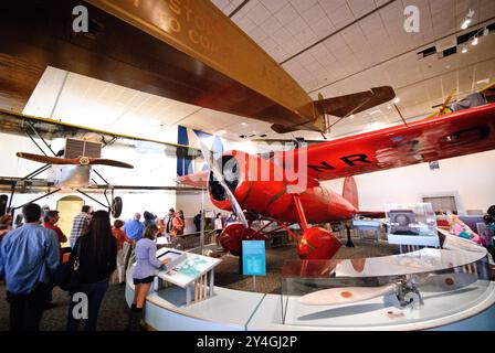 WASHINGTON DC, United States — Amelia Earhart's historic Lockheed Vega 5B (registration NR-7952) stands preserved at the Smithsonian's National Air and Space Museum. This distinctive red aircraft carried Earhart on her groundbreaking solo transatlantic flight in 1932 and her solo transpacific flight in 1935. The Vega represents one of the most significant aircraft in women's aviation history. Stock Photo