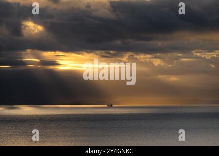 Spectacular sunset in Adriatic Sea near Croatia, rainy clouds and a ship Stock Photo